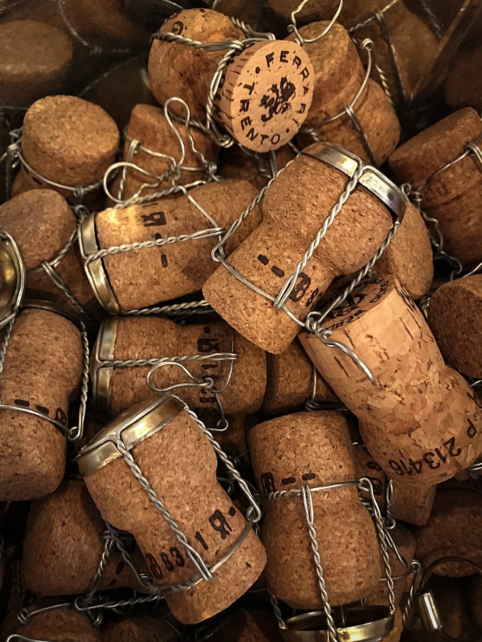 A collection of champagne bottle corks with metal cages in a close-up view.